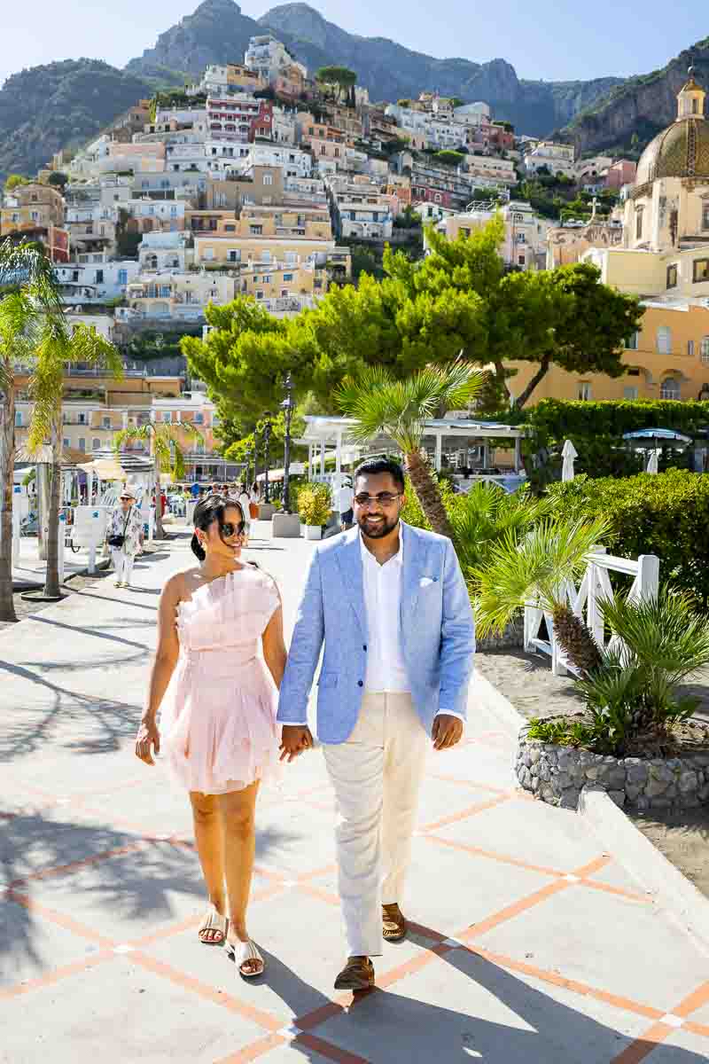 Walking photoshoot along the coastal boardwalk at sea level with a majestic background.