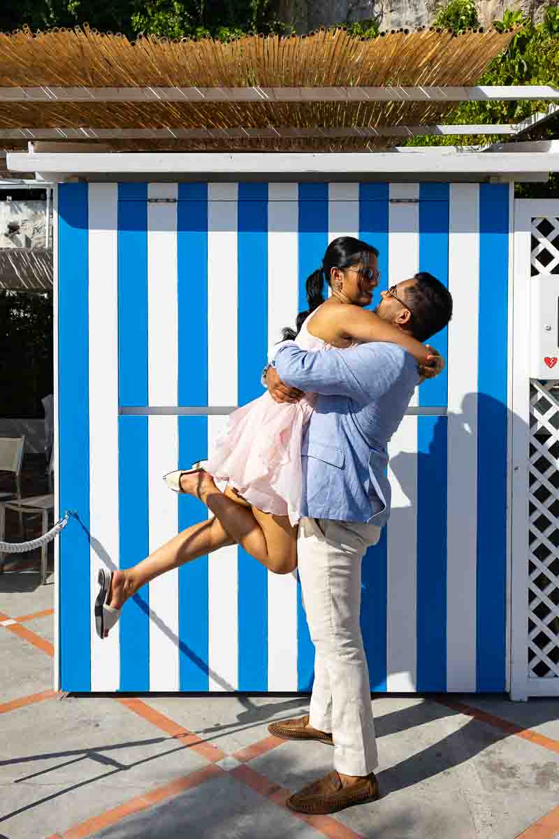 Playful lift-up snapshot celebrating a joyful journey against iconic seaside colors.