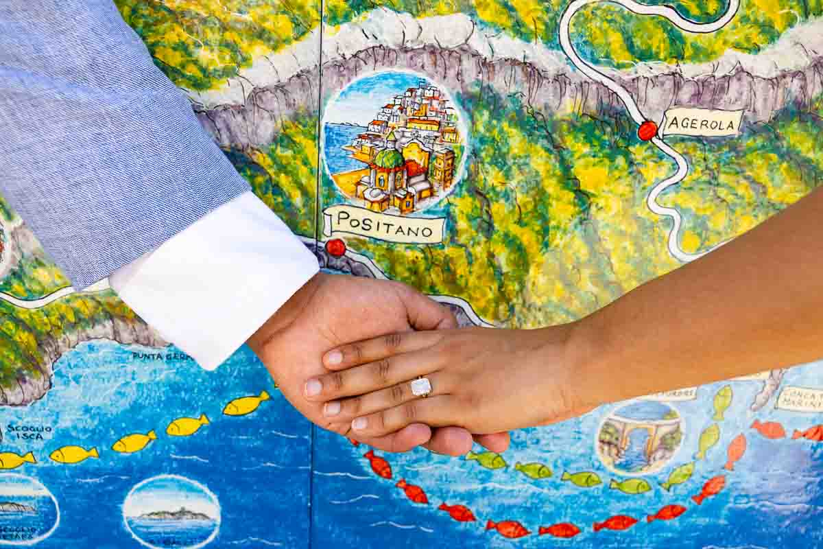 Detail macro shot of a sparkling ring placed over hand-painted tiles showing regional town names.