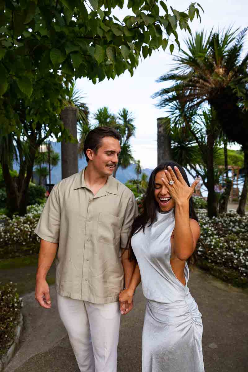 Showing the engagement ring at the camera with happiness.