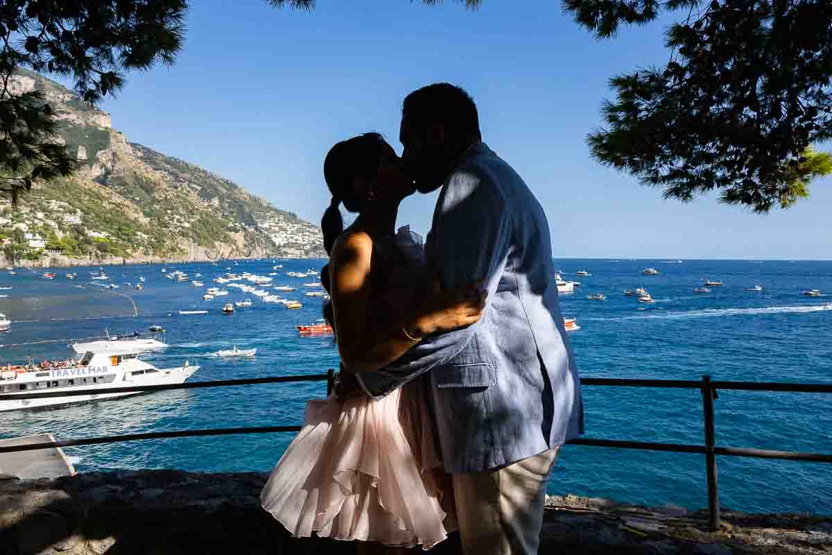 Artistic photography silhouette of a final romantic kiss set against vivid dusk sky tones.