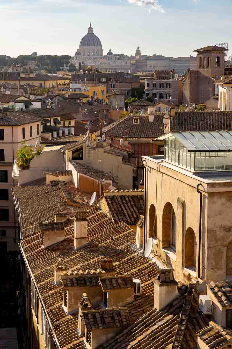 Panoramic view across the historic terracotta Roman rooftops from Terrazza Borromini.
