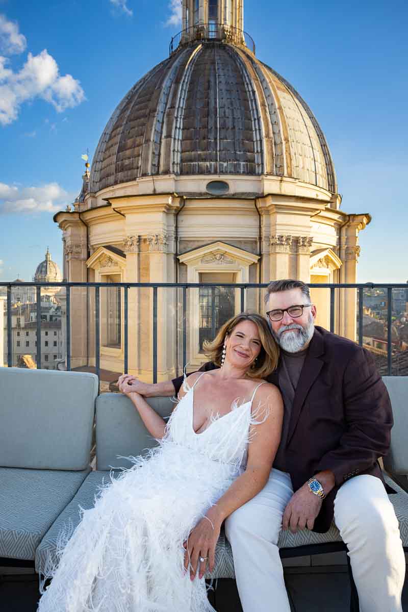 An intimate portrait of the couple sitting together with a majestic church dome in the background.
