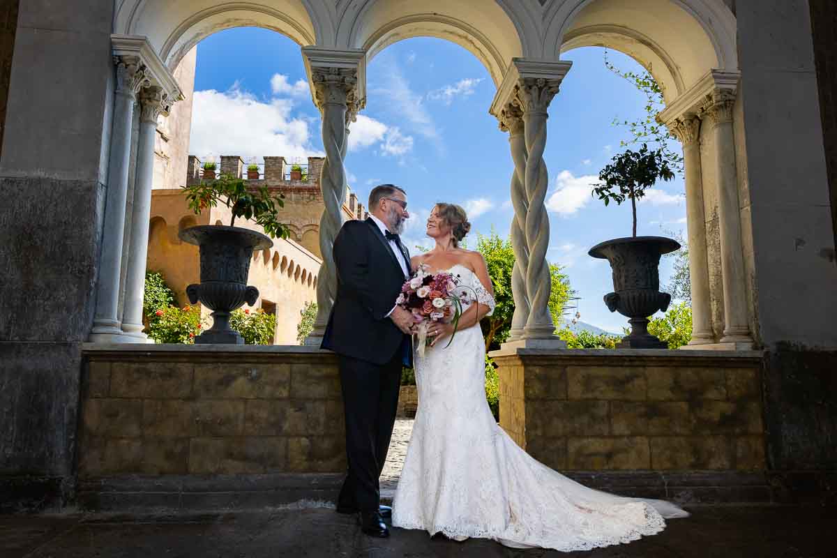 The couple sharing a quiet moment during their portrait session under a vaulted portico. Photoshoot start of picture taking