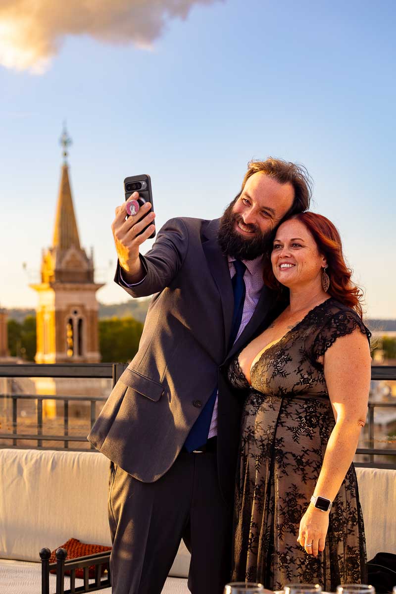 A candid mobile phone selfie capturing friends smiling together during the evening.