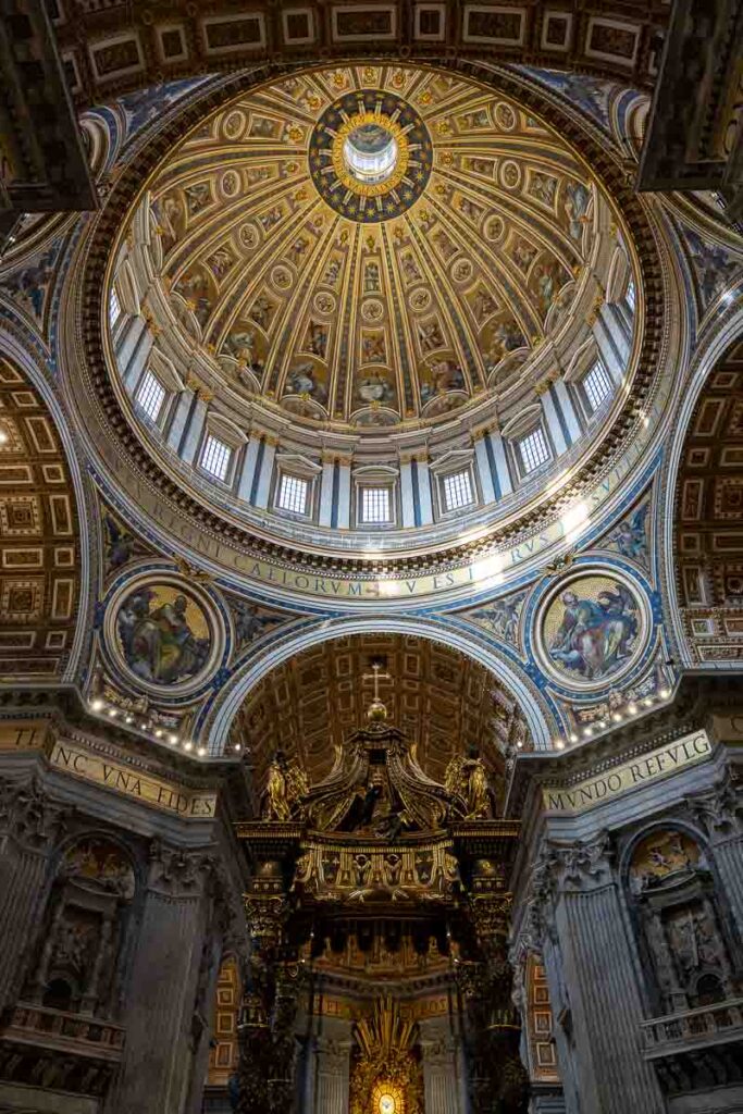 Panoramic upwards perspective showcasing the intricate gold artwork patterns decorating the massive overhead vault dome