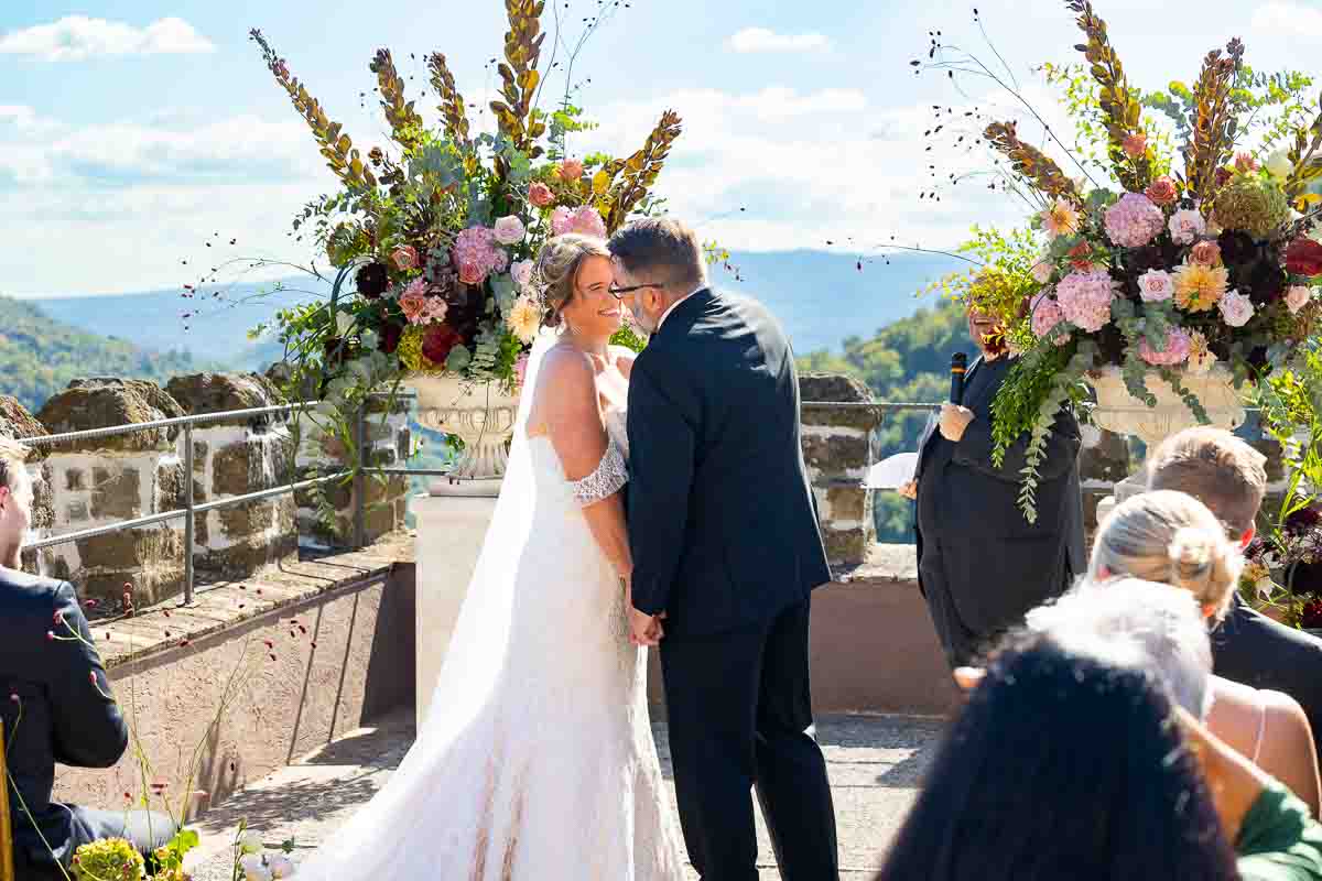 The joyful newlyweds sharing their first kiss as husband and wife on the terrace.