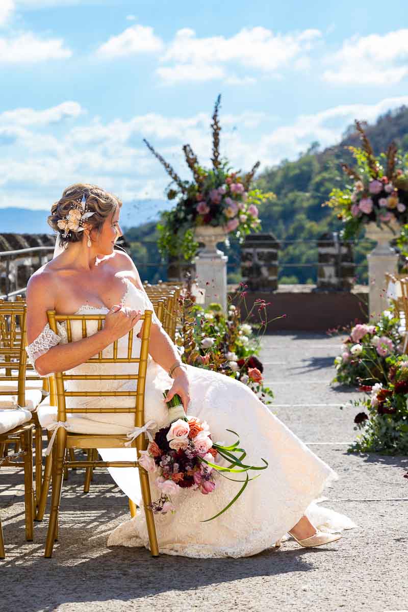 A timeless bridal portrait capturing the bride sitting elegantly on a historic indoor chair.