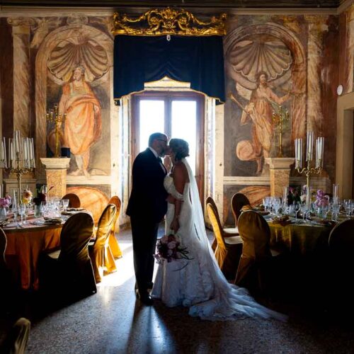 A quiet, romantic moment shared between the couple inside the frescoed palace hall. Artistic destination wed photography session