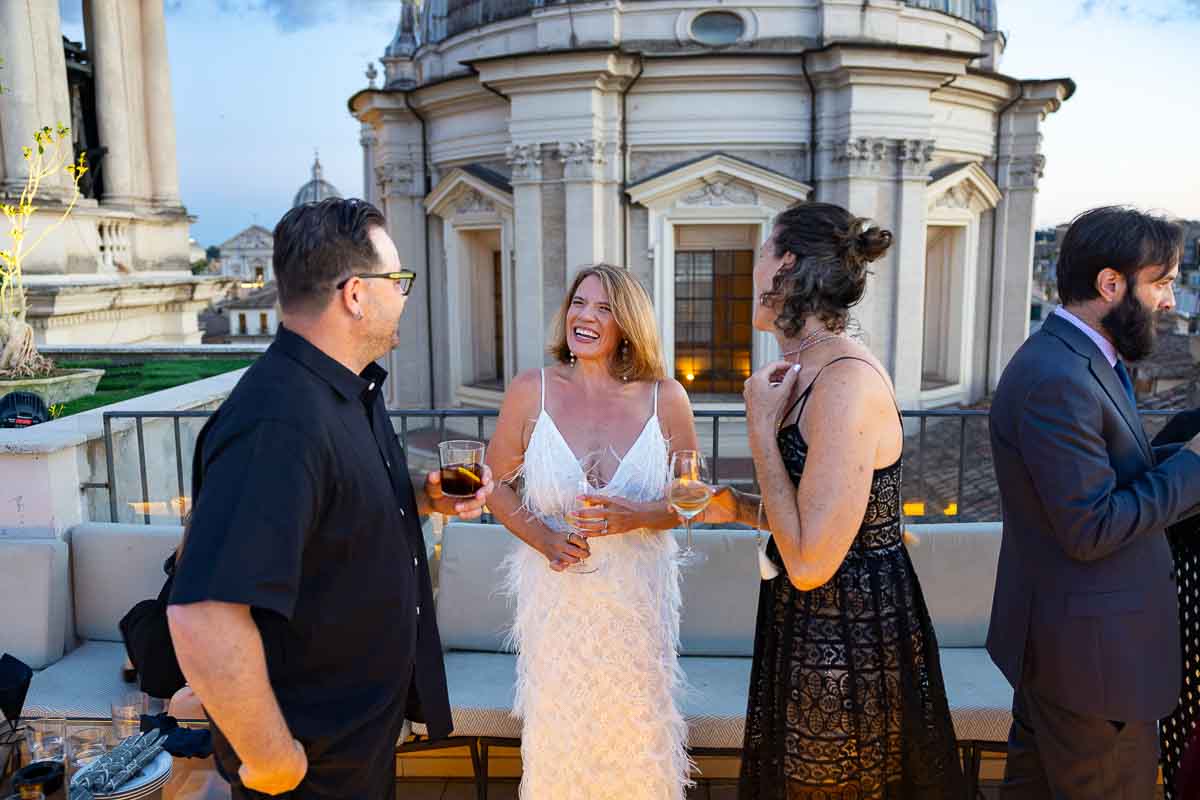 The groom-to-be moving through the rooftop space and talking to arriving guests.