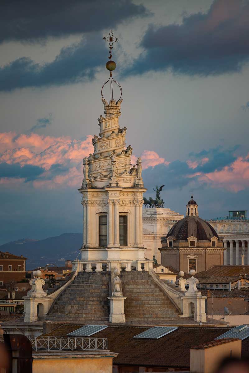 The illuminated stone details of Sant'Agnese church against the transitioning evening sky.