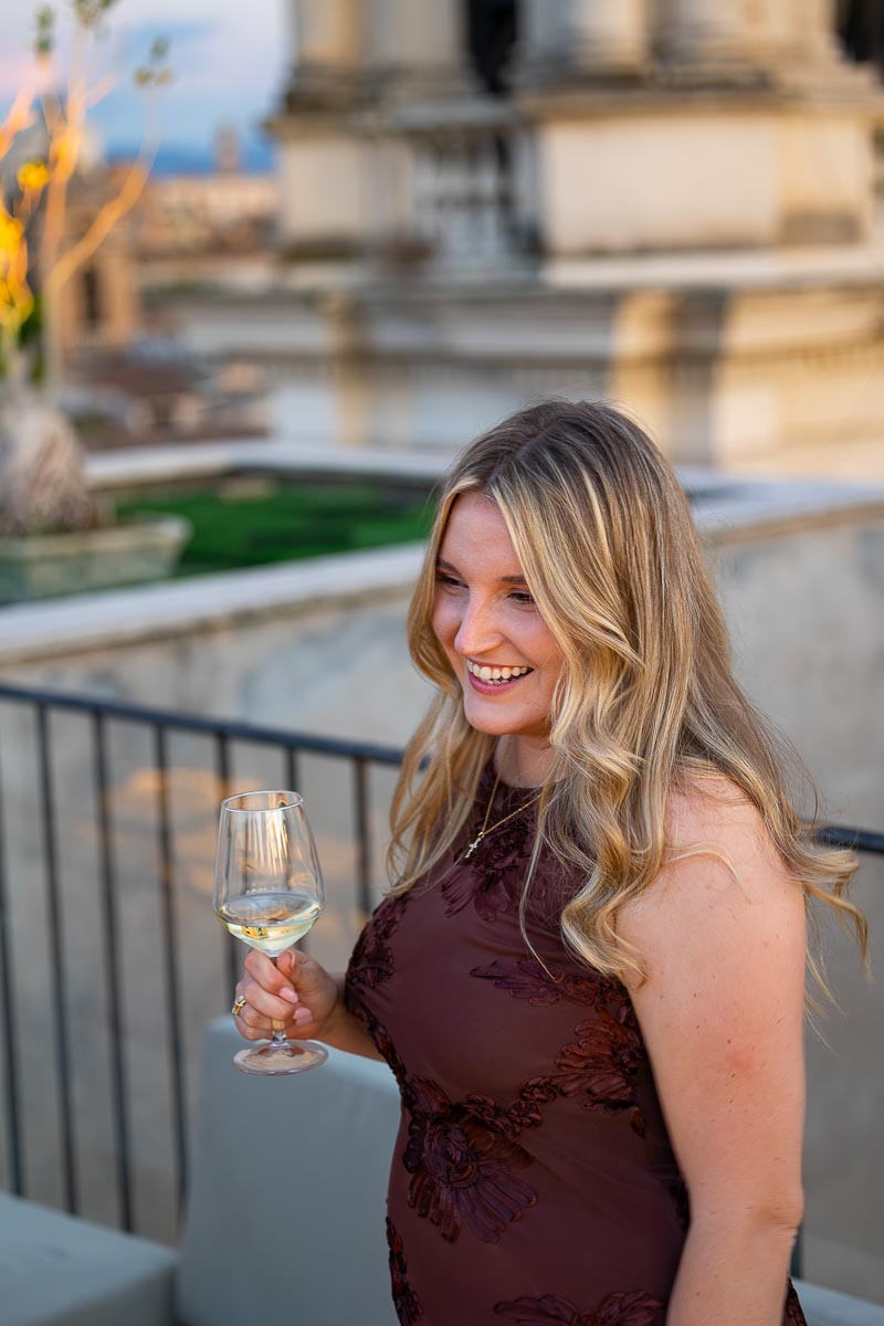 A group of wedding guests holding up their wine glasses in celebration.