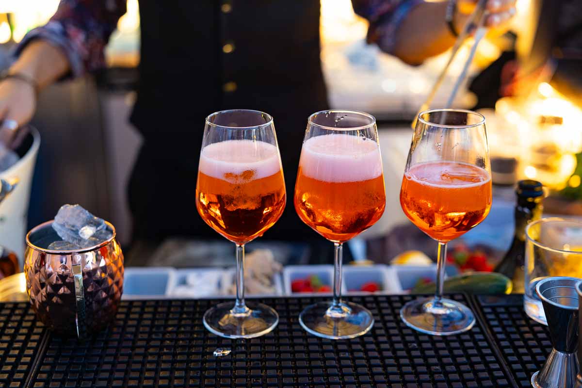 An Italian Aperol Spritz cocktail being freshly prepared at the terrace bar.