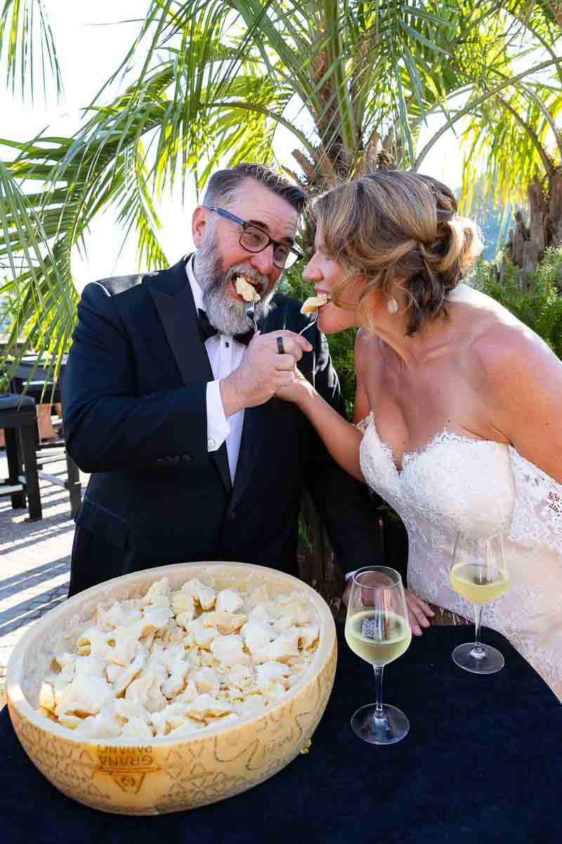The couple enjoying an authentic culinary experience tasting aged Italian Parmigiano cheese captured in photographs