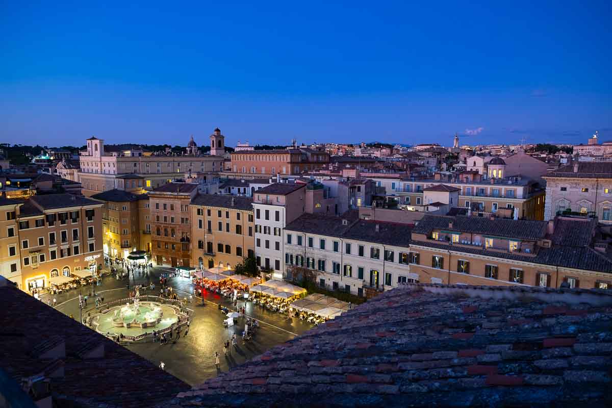Looking down at the beautiful Piazza Navona fountain illuminated at night.