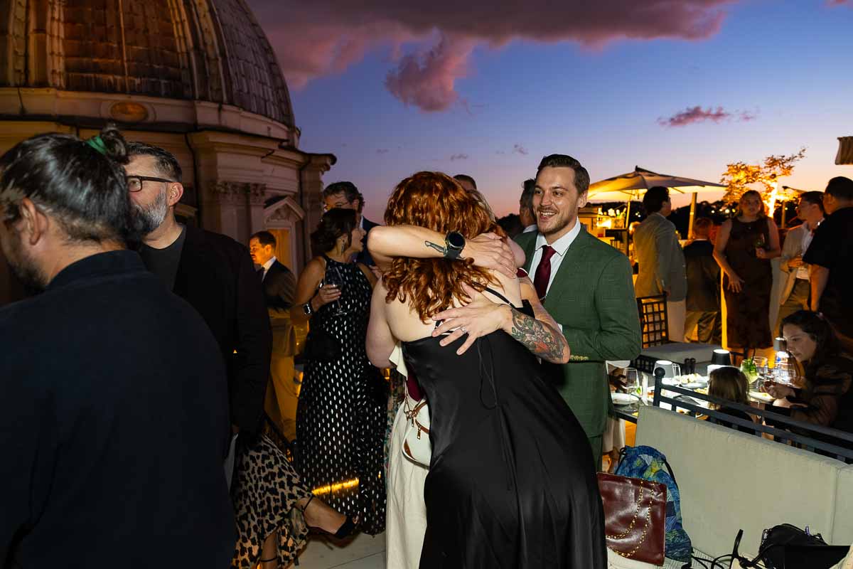 Family members embracing and welcoming each other as they arrive at the party.