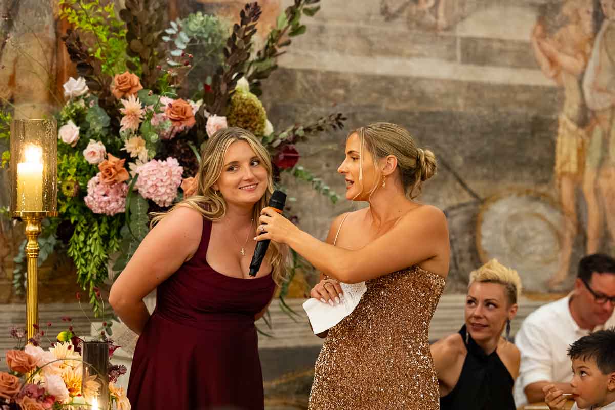 A group of bridesmaids laughing together during the heartfelt maid of honor speeches.