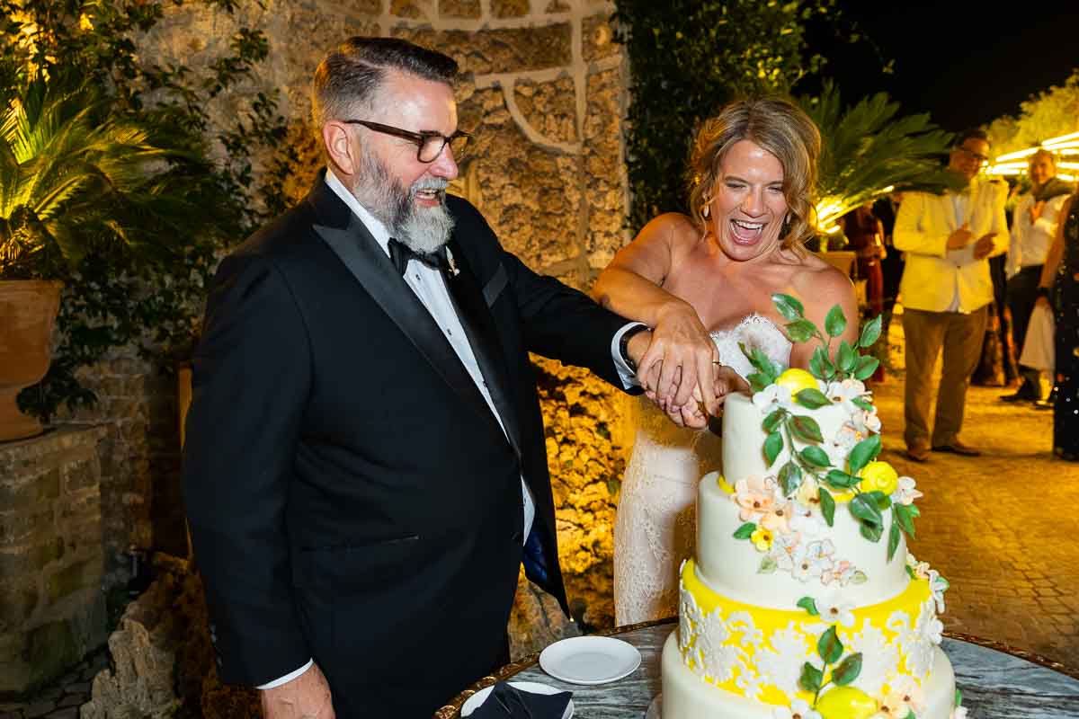 The traditional cutting of the beautiful wedding cake surrounded by hanging courtyard lanterns.