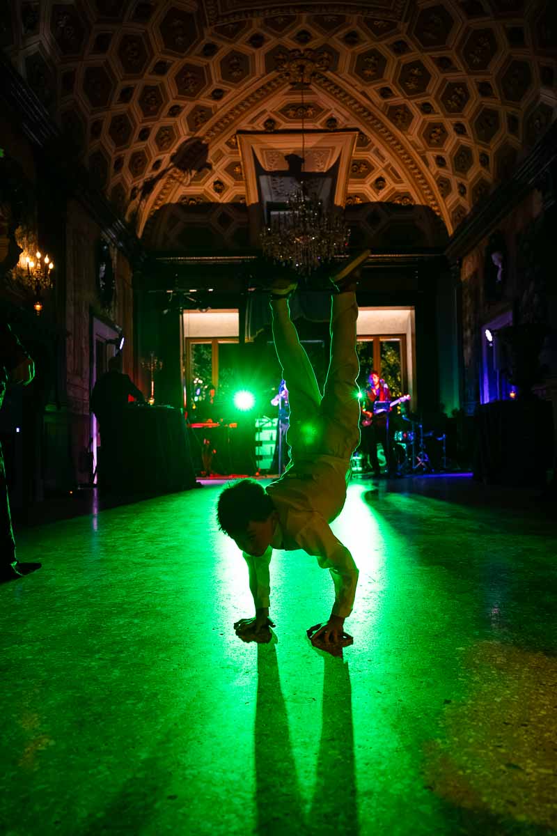 Vibrant action shots of guests dancing to a live band in an illuminated ballroom.