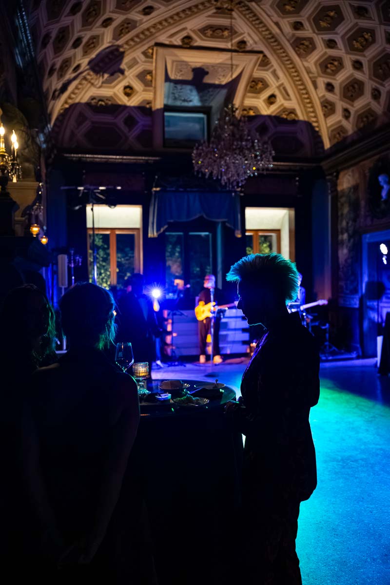 Energetic party photography under colorful green and red event lighting.