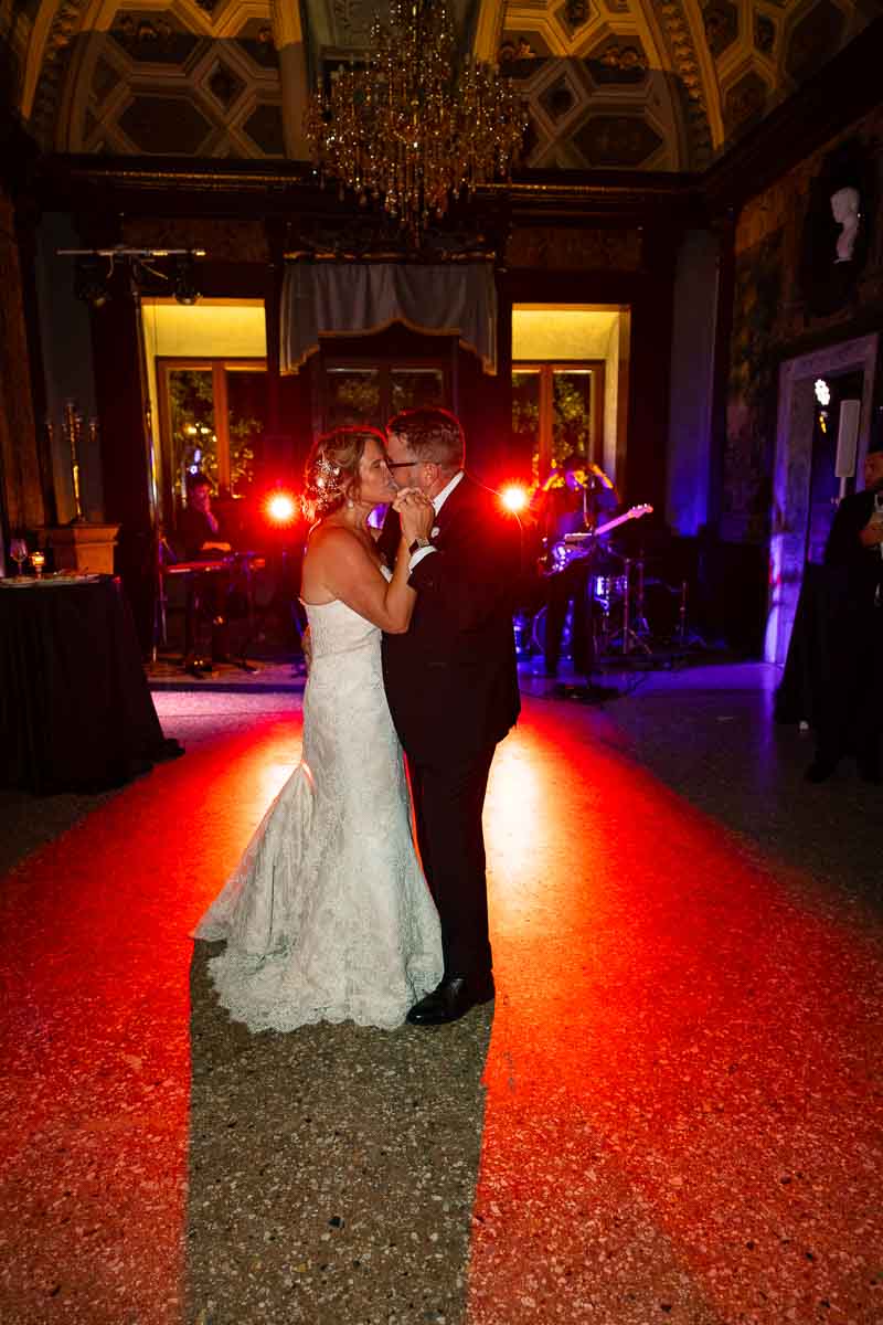 Friends letting loose on a packed dance floor as the live musical performance peaks.