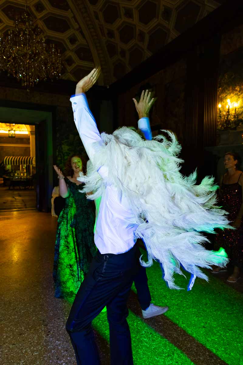 A high-energy shot of the groom being lifted up by his friends on the dance floor.