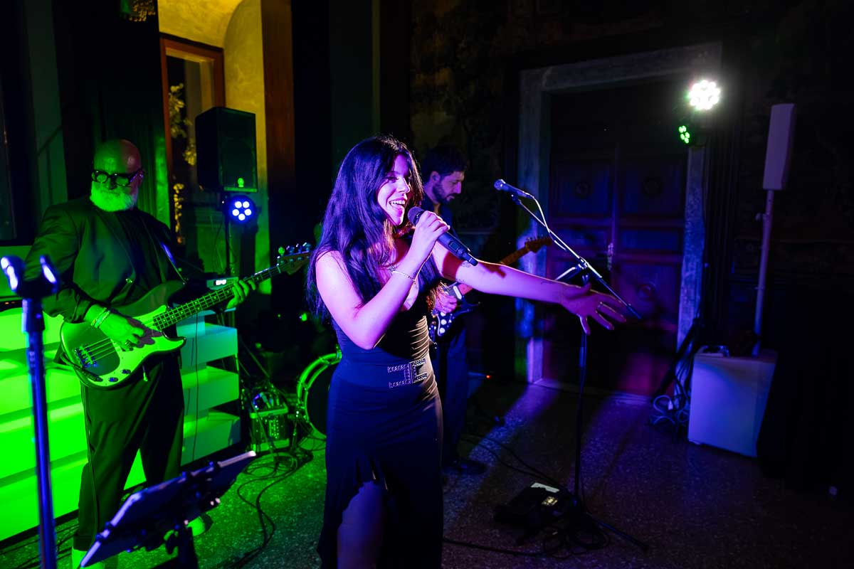 The live band musicians interacting directly with the crowd from the ballroom stage.