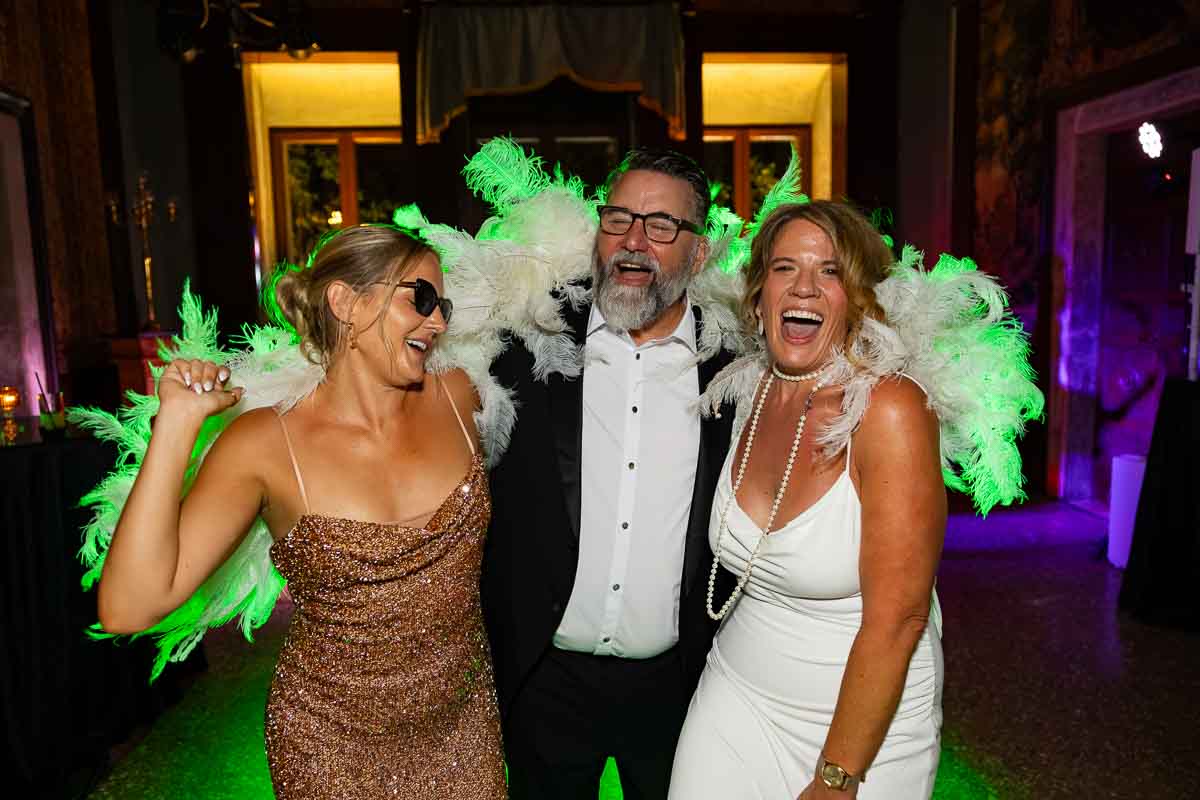 Colorful light streaks creating a dynamic sense of motion across the energetic dance floor. Portrait photos groom & bride