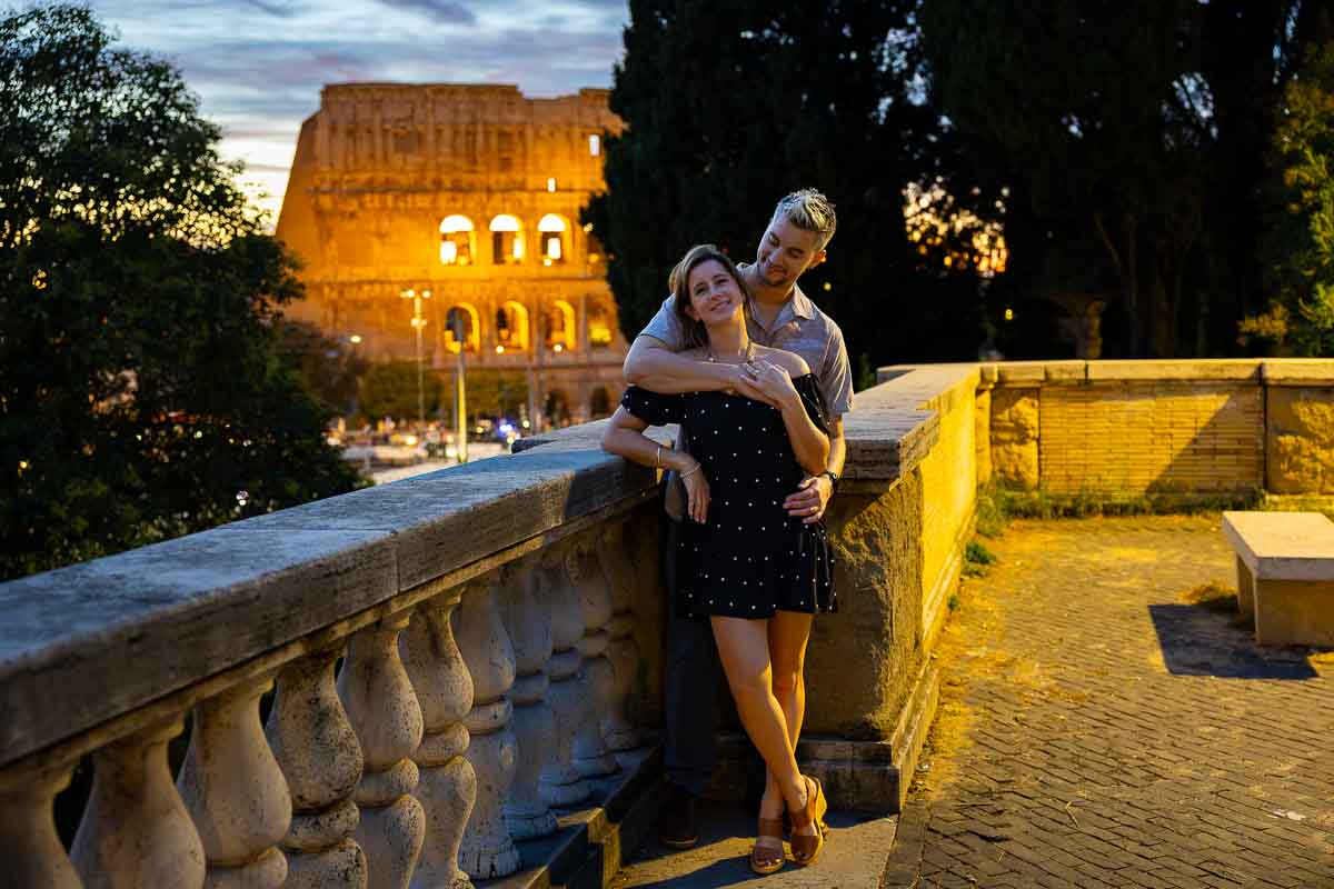A final romantic portrait of the couple standing together under the warm glow of an atmospheric street lamp.